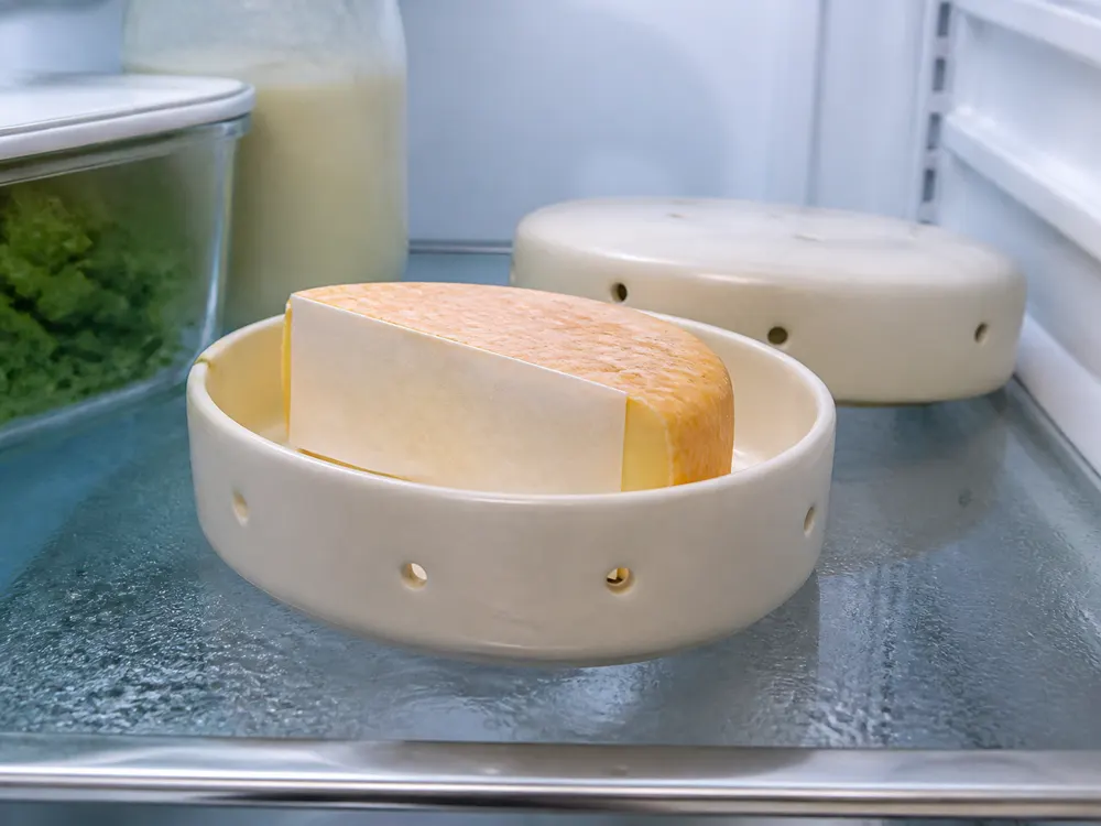 Citeaux-style wedge with its cut face covered in a ventilated cheese box - Abbaye de Citeaux | KnowTheCheese