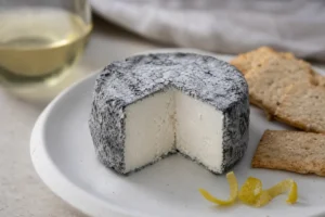 Cut ash-rinded goat cheese round - Acapella cheese | KnowTheCheese