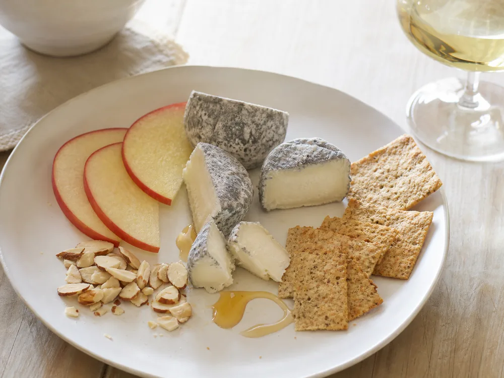 Acapella-style goat cheese plate with apple, almonds, crackers, and white wine - Acapella cheese | KnowTheCheese