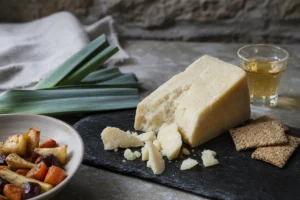 Hard Welsh sheep cheese wedge with leeks oat crackers and cider - Acorn | KnowTheCheese
