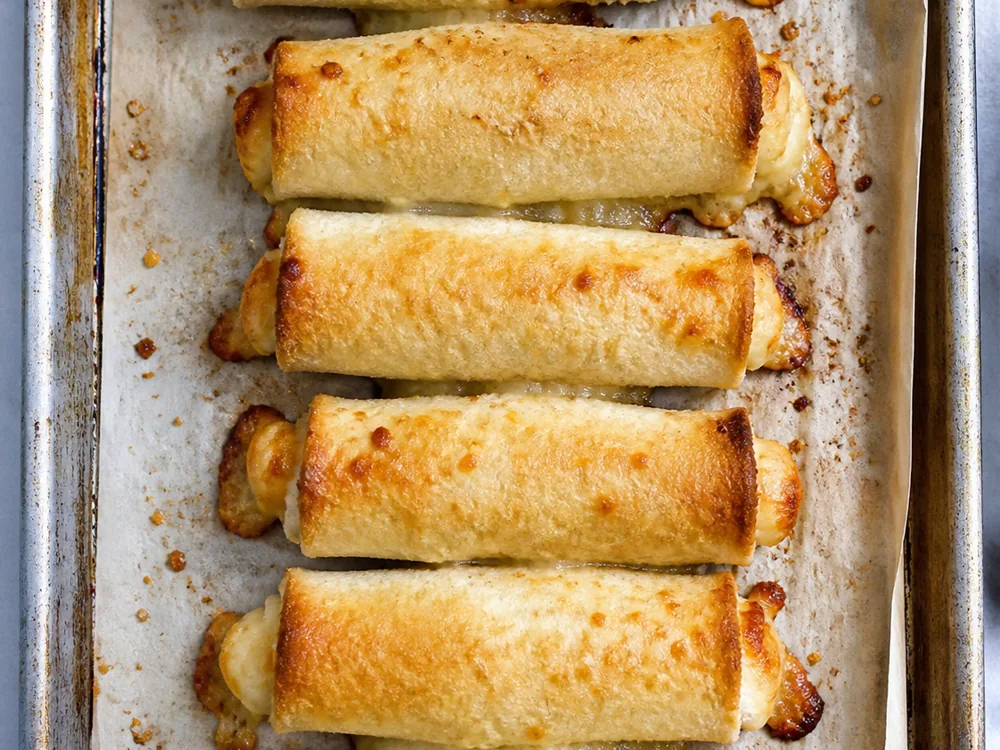 Tray of baked Southland cheese rolls, golden and crisp with filling at the seams - Airedale | KnowTheCheese