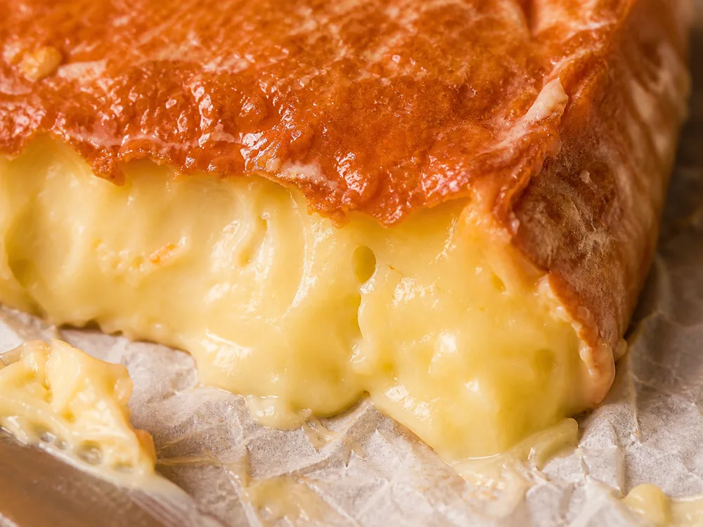 Orange-brown washed rind and creamy paste detail - Ameribella | KnowTheCheese