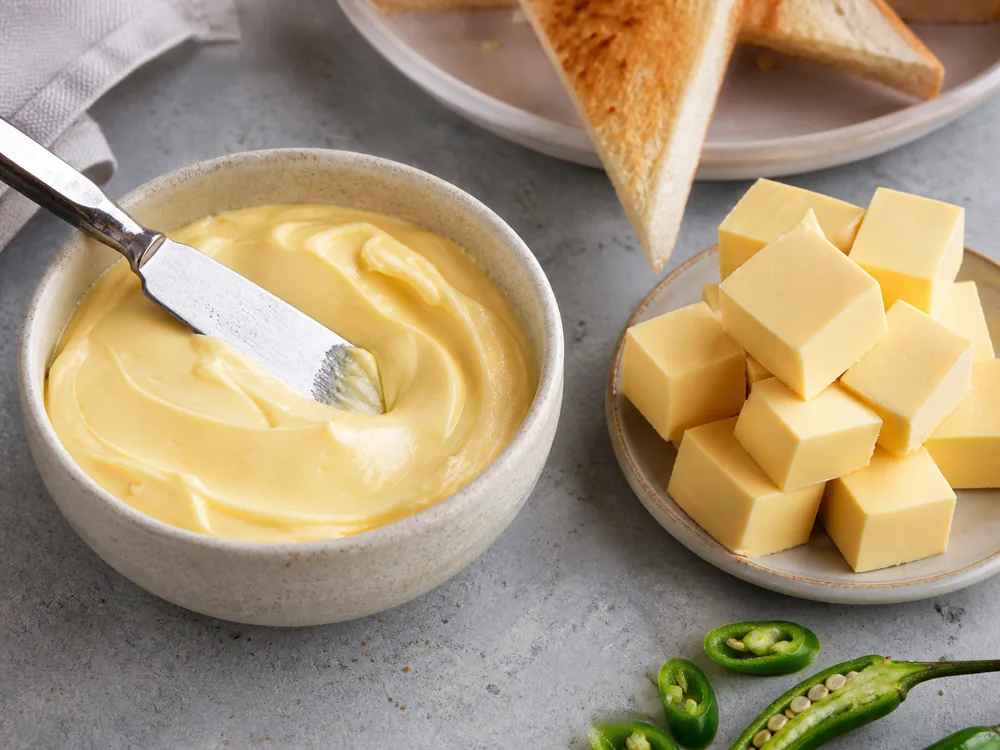 Smooth cheese spread beside processed cheese cubes and toast - Amul Cheese Spread | KnowTheCheese