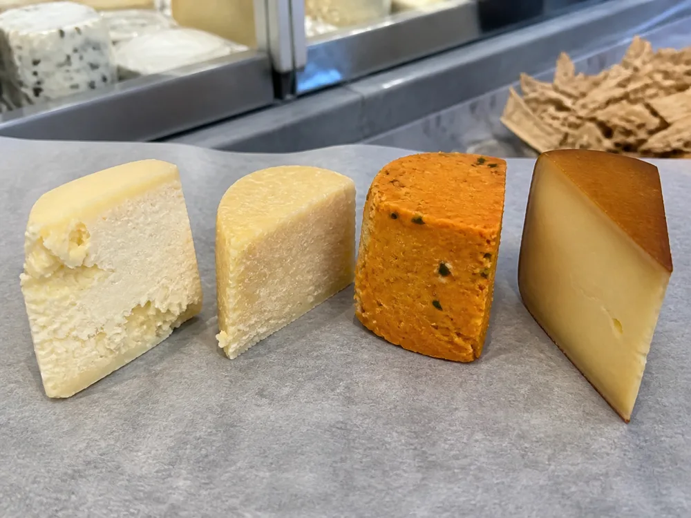 Four Anster-style cheese variants with distinct color texture and finish - Anster | KnowTheCheese