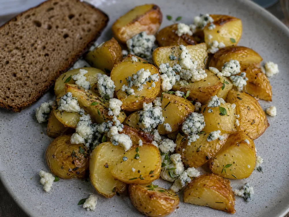 Blue cheese crumbles over roasted potatoes and rye toast - Aura Cheese | KnowTheCheese