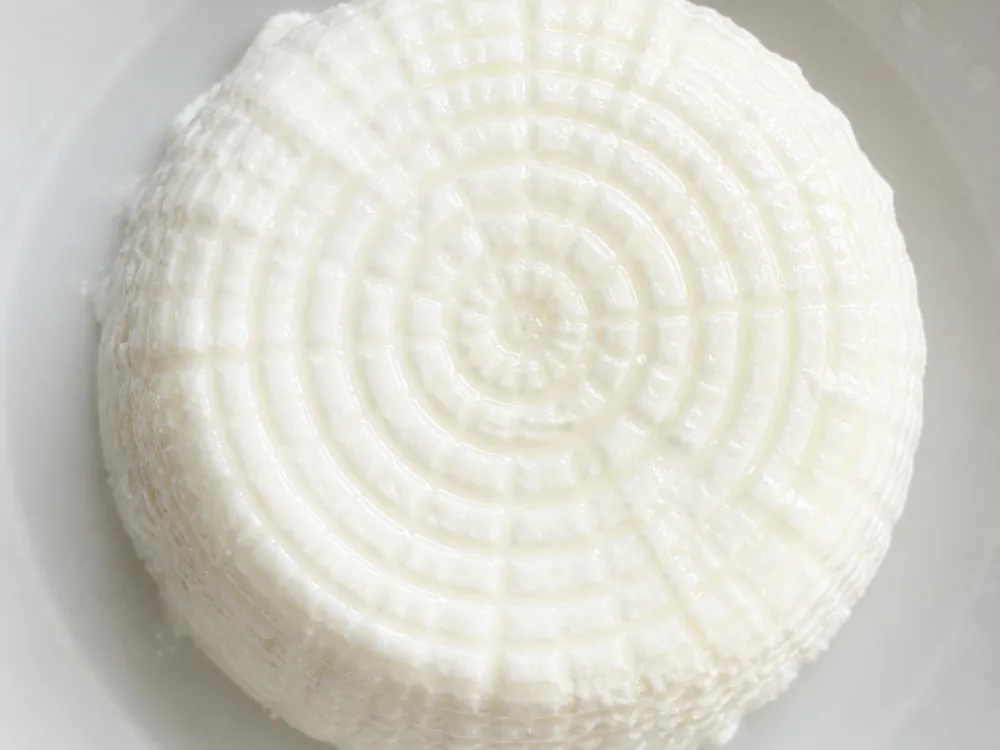 Basket weave grid pressed into the moist white surface of the cheese - Basket Cheese | KnowTheCheese