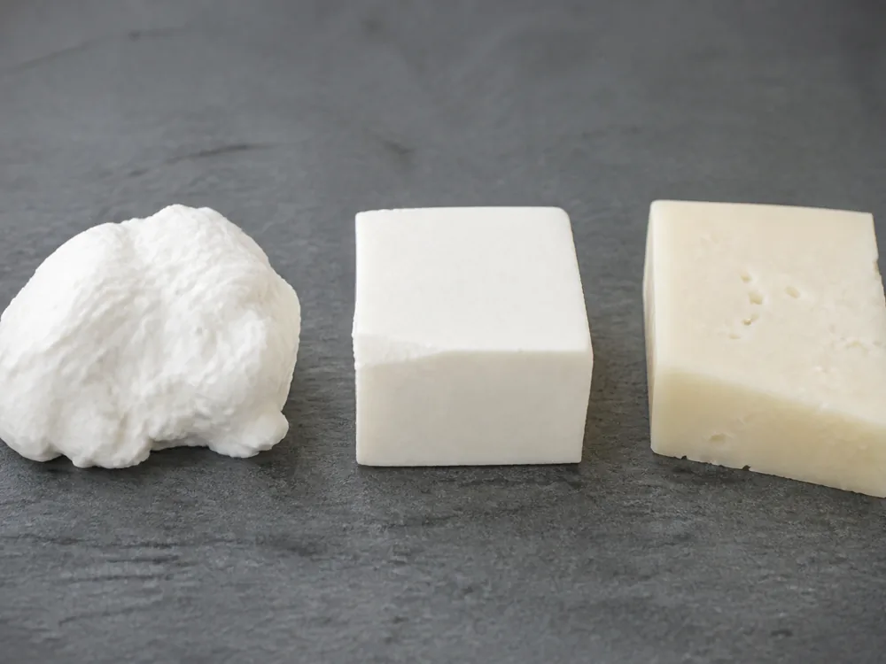 Three pieces of white cheese in a row running soft and bright white on the left to firm and faintly straw coloured with small holes on the right - Beyaz Peynir | KnowTheCheese