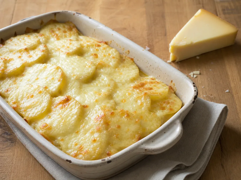 Potatoes under a smooth pale Bianco cheese melt - Bergader Bianco | KnowTheCheese