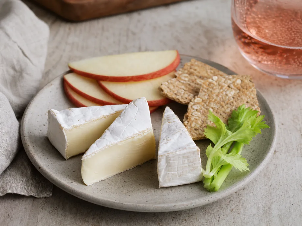 Small Bix-style triple-cream cheese portions with apple crackers and sparkling rose - Bix | KnowTheCheese