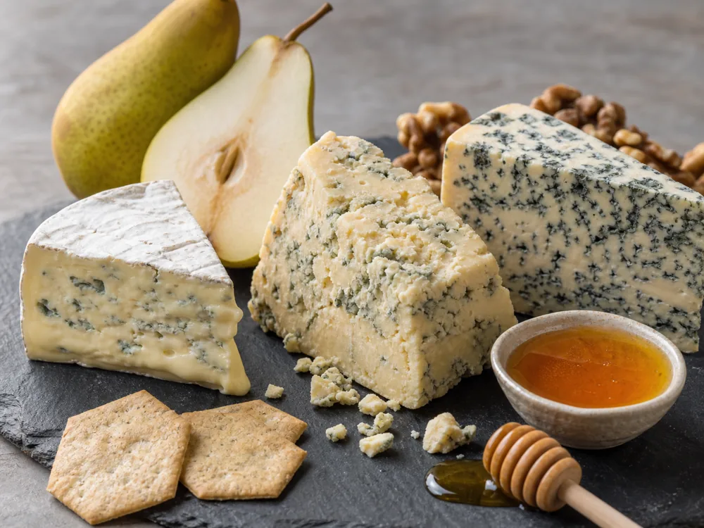 Three blue cheese styles showing creamy, crumbly, and heavily veined textures - Blue cheese | KnowTheCheese