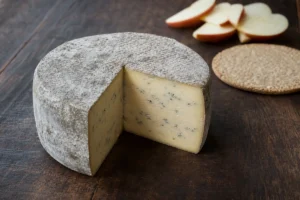 Small Bluebell cheese truckle with gray rind and pale blue veins