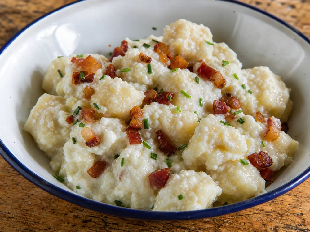 Potato dumplings coated with softened Bryndza and small bacon pieces - Bryndza | KnowTheCheese