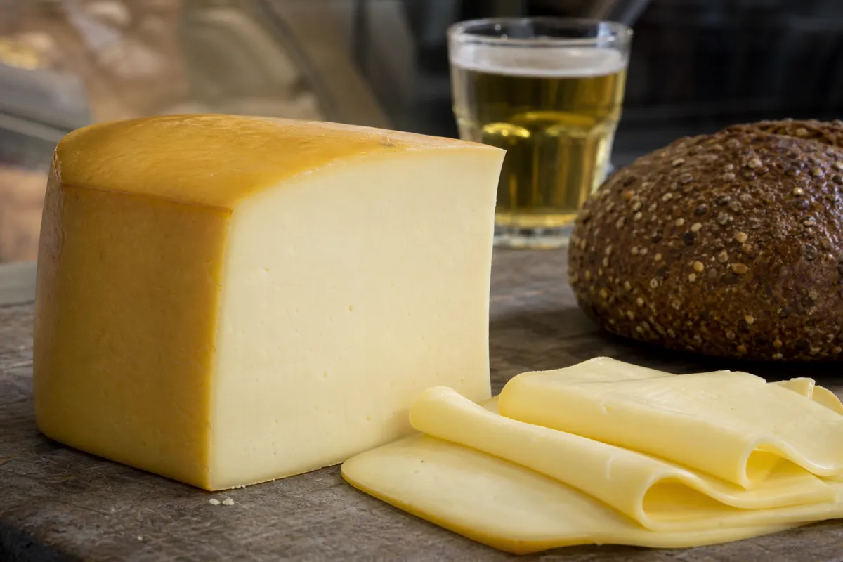 Pale Butterkase loaf with thin flexible slices and rye bread - Butterkase Cheese | KnowTheCheese
