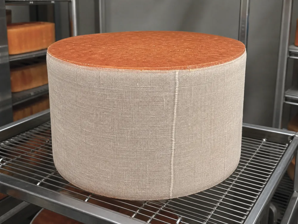 Clean cloth wrapped around a russet blue cheese cylinder - Buxton Blue | KnowTheCheese