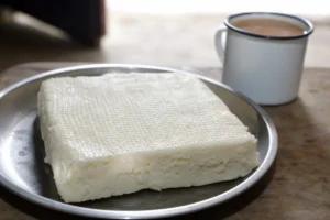 Fresh Mongolian byaslag cheese cut into pale pressed slabs