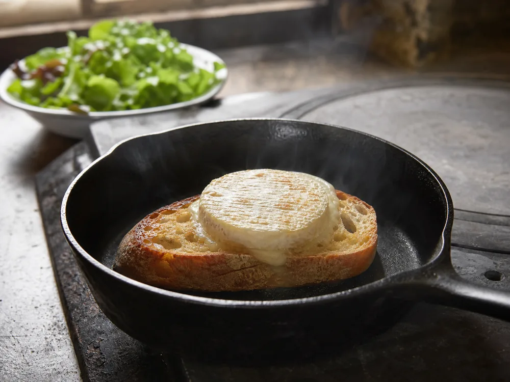 Warm round goat cheese on toast over a bitter-leaf salad - Cabécou | KnowTheCheese