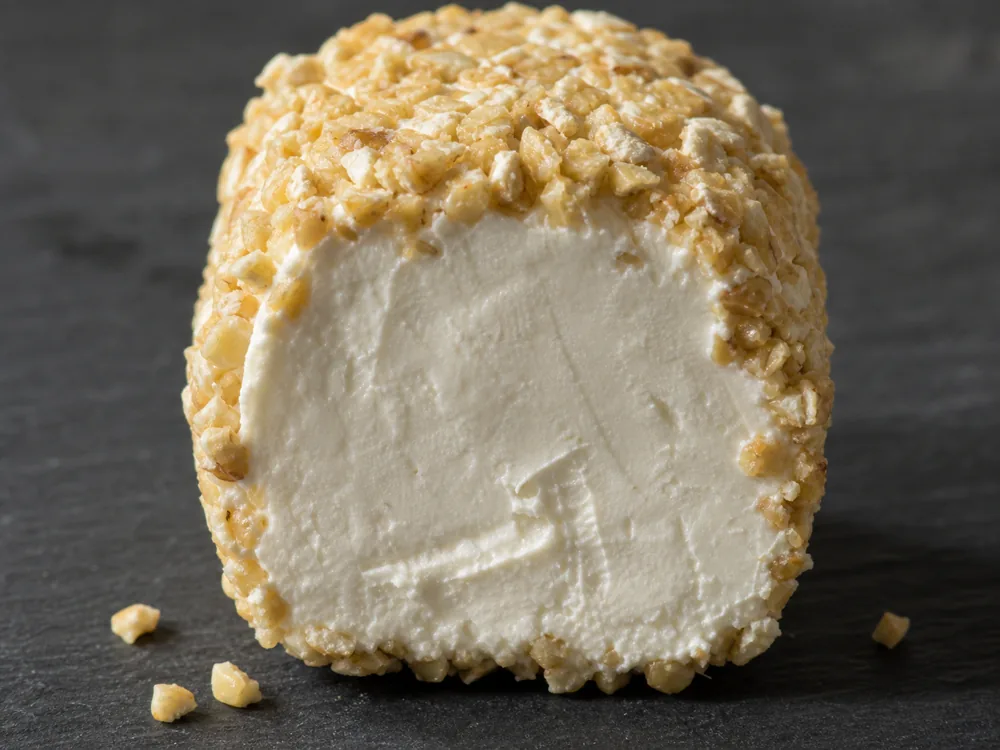 Coarse pinhead oatmeal coating around a white double-cream cheese | KnowTheCheese