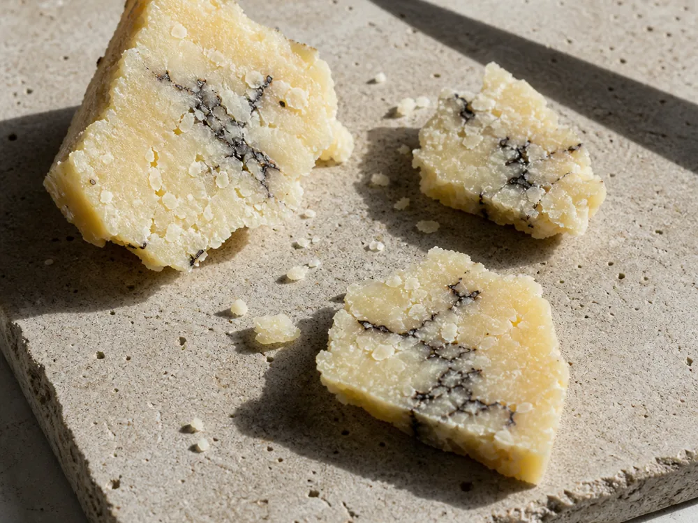 Broken shards showing the crumbly texture of truffle pecorino | KnowTheCheese