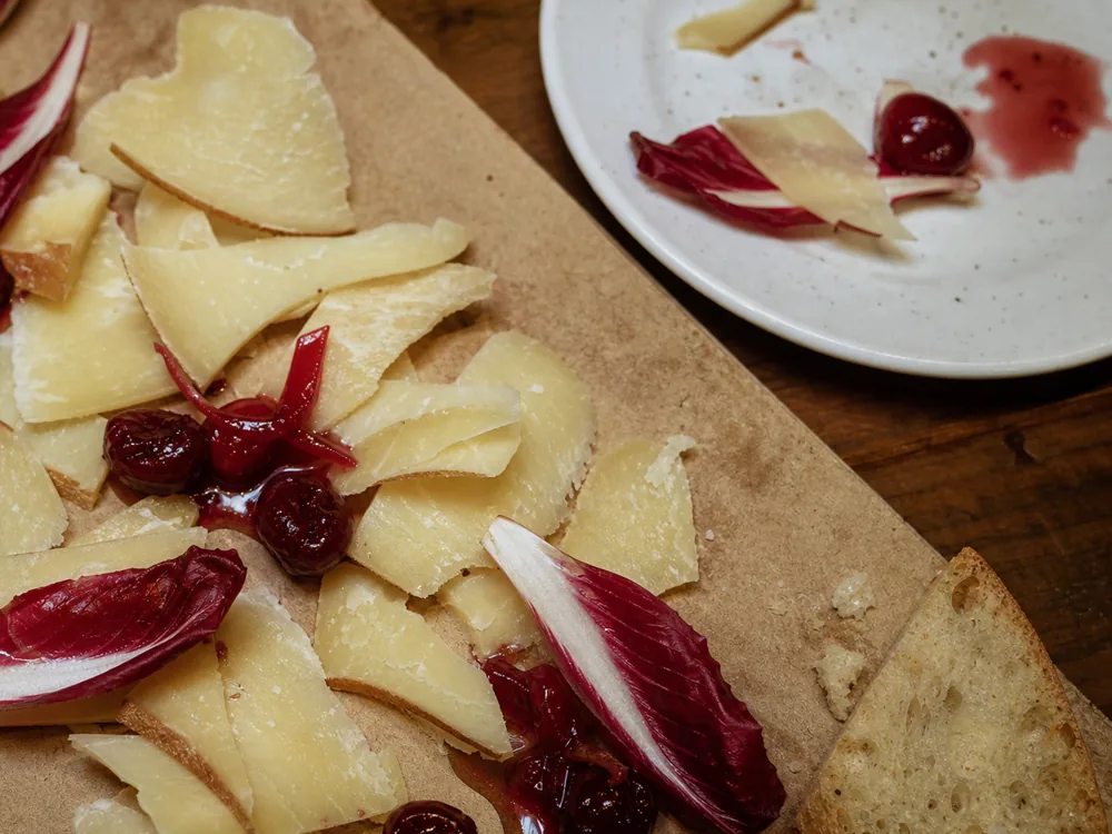 Thin Caciobarricato slices with chicory, bread, and sour cherry mostarda | KnowTheCheese