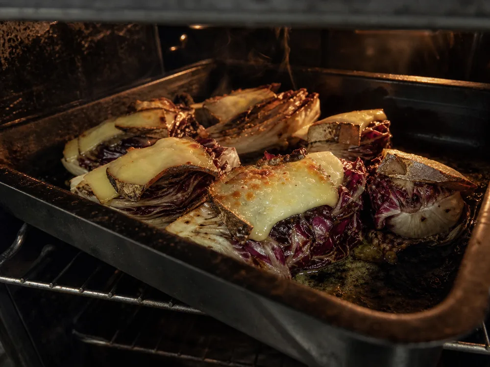 Small pieces of Caciobarricato browned over roasted radicchio | KnowTheCheese