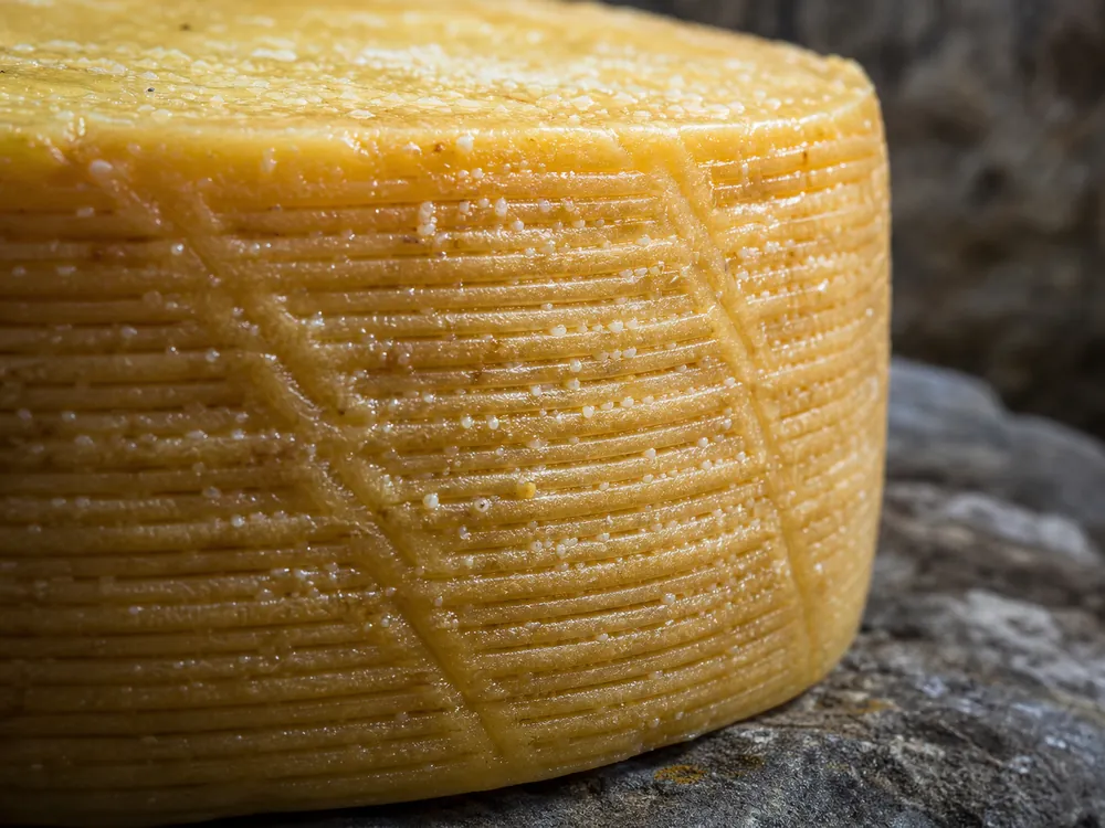 Close view of woven basket impressions on a Canestrato-style rind | KnowTheCheese