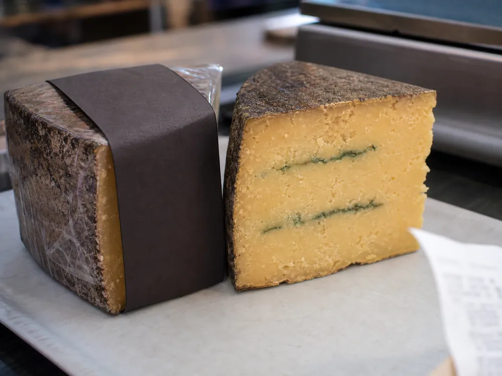 Wrapped and open Castelmagno-style wedges showing label and maturity cues | KnowTheCheese