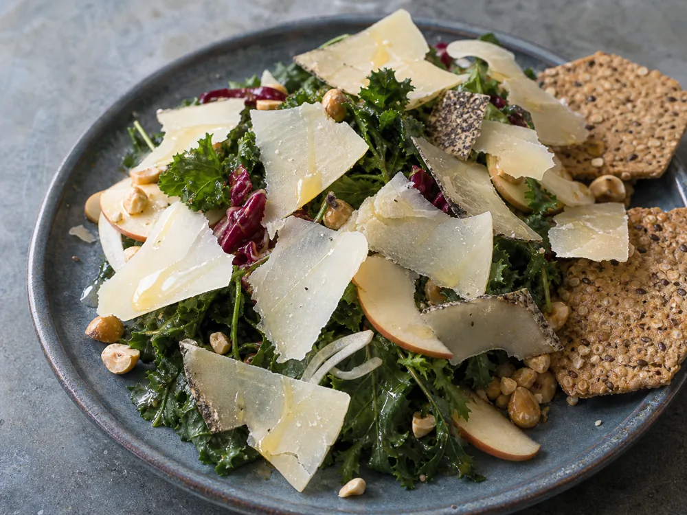 Shaved cave-aged sheep cheese over greens with honey and hazelnuts - Cave Aged Marisa | KnowTheCheese