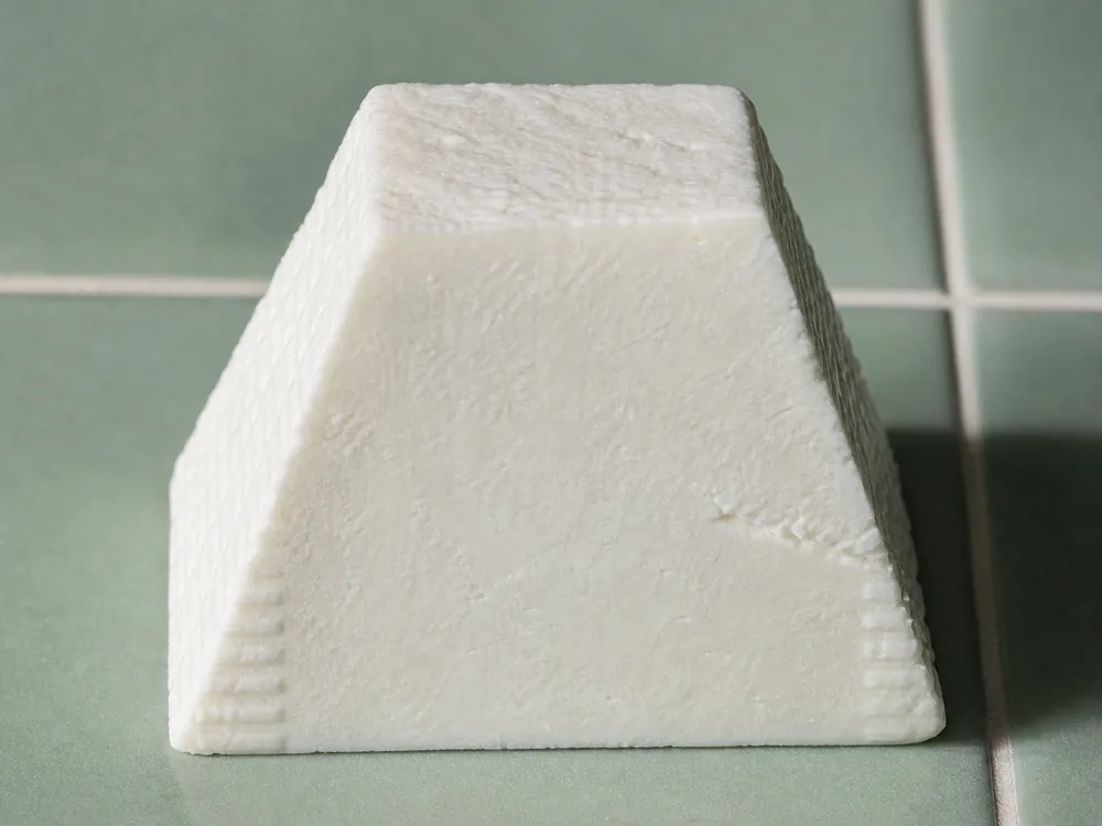 Cut fresh goat cheese pyramid showing its smooth dense center | KnowTheCheese