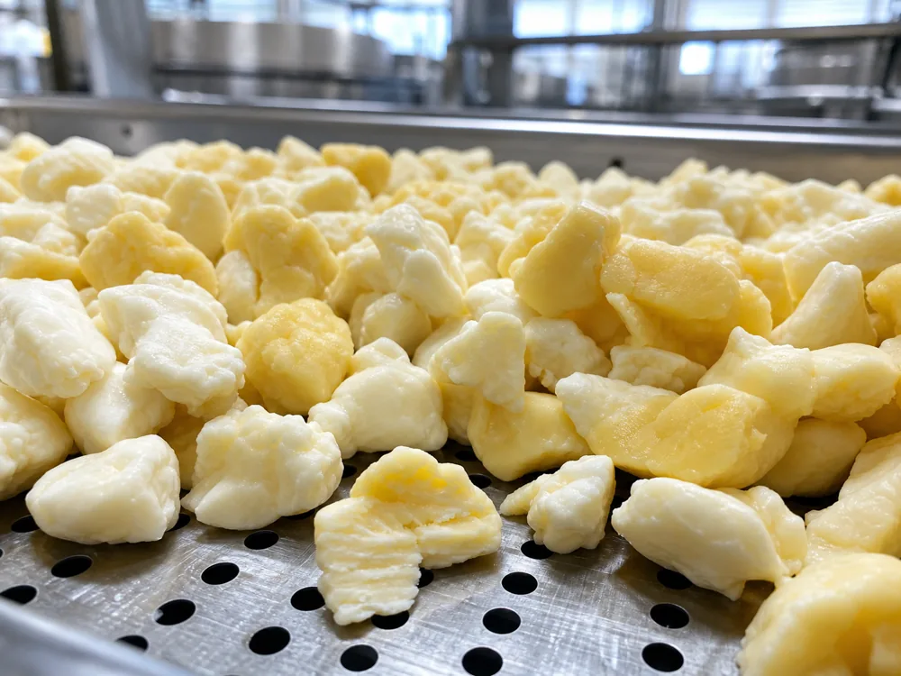 Fresh Wisconsin cheese curds on a creamery tray - Cheese Curds | KnowTheCheese