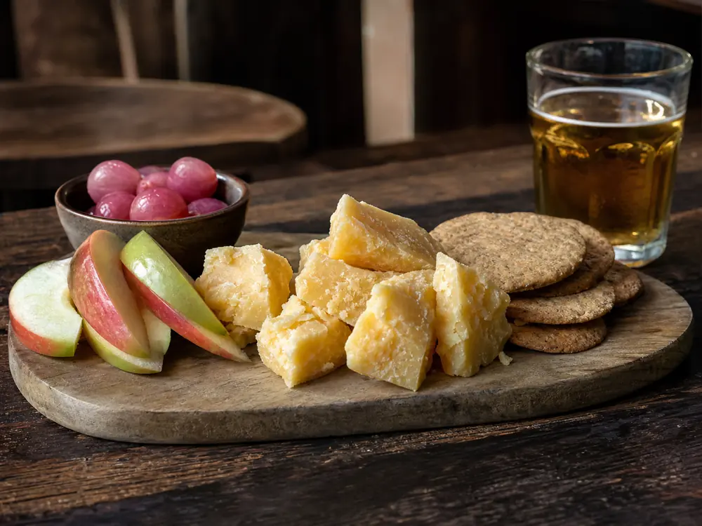 Coastal Cheddar chunks with apple pickled onion oat biscuits and dry cider - Coastal Cheddar | KnowTheCheese