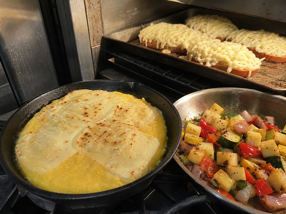 Colony cheese browned on polenta melted over bread and cubed with vegetables - Colony Cheese | KnowTheCheese