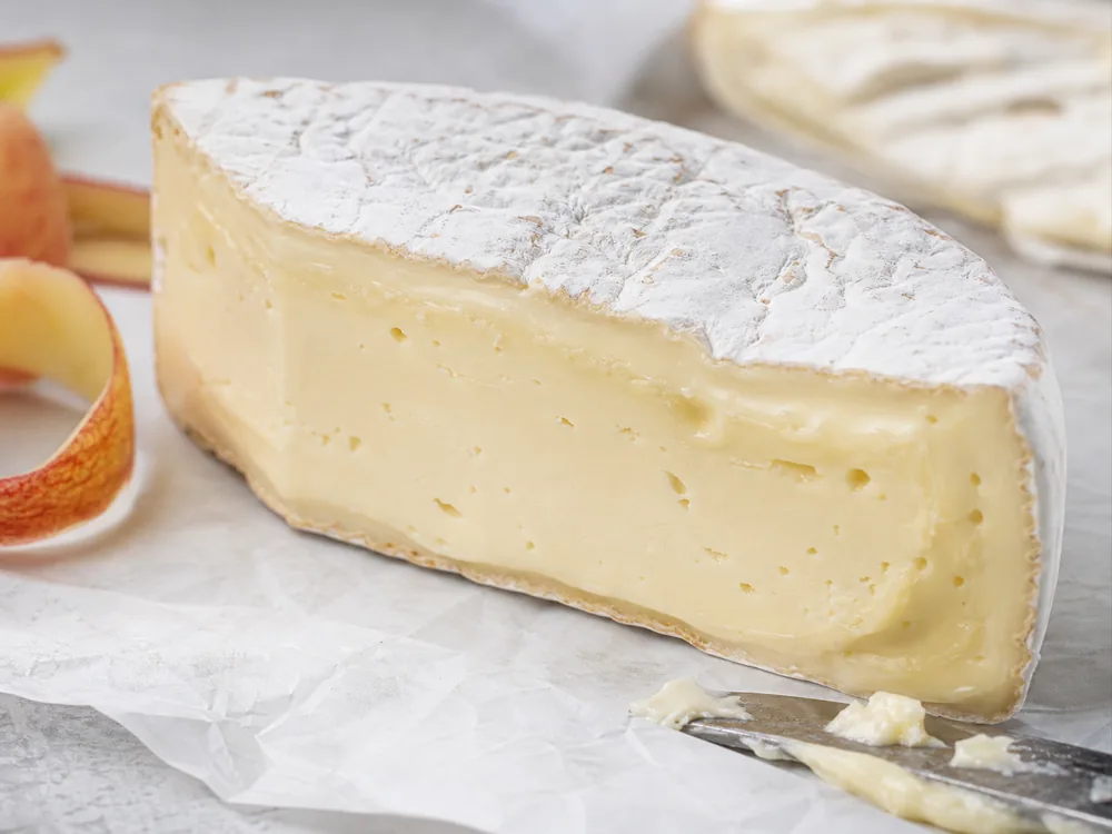 Brie style cheese cut face with rind creamline and firmer center - Comox Brie | KnowTheCheese