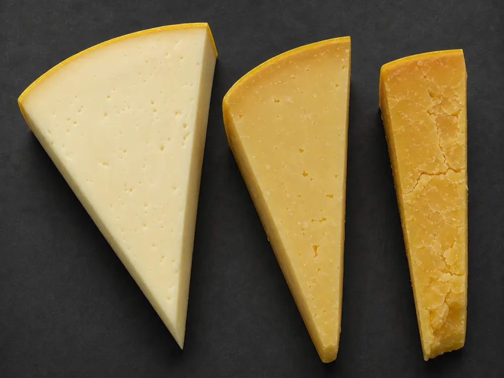 Young medium and mature Coolea cuts showing deeper color and firmer texture - Coolea | KnowTheCheese