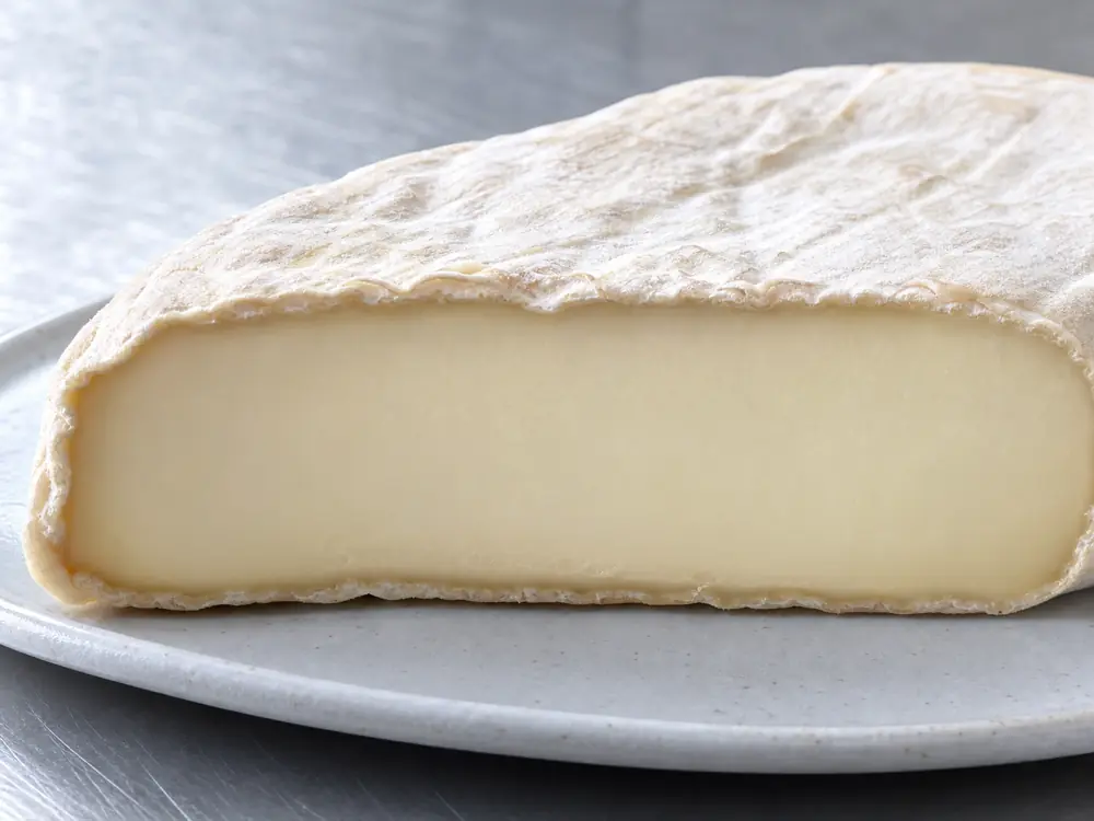 Smooth pale interior beneath a thin wrinkled rind - Cremont cheese | KnowTheCheese
