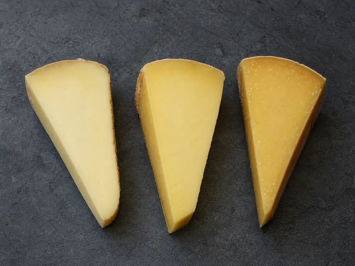 Three pale Crowley wedges becoming firmer and deeper in color with age - Crowley cheese | KnowTheCheese