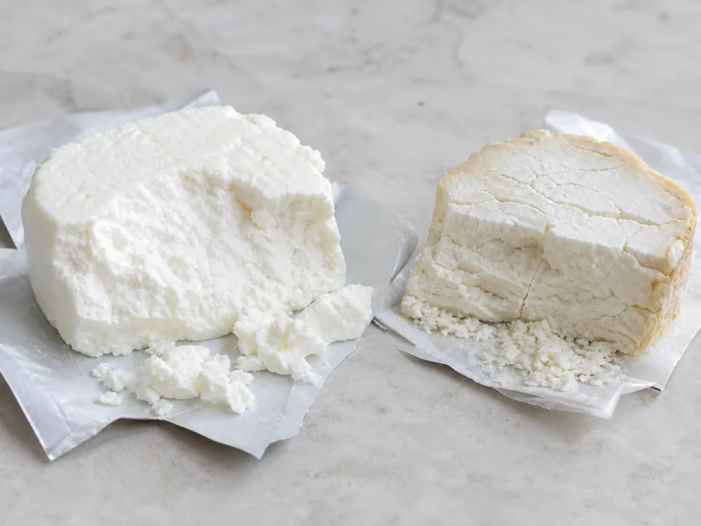 Moist bright-white crumbly cheese beside a dry cracked piece - Crumbly Lancashire cheese | KnowTheCheese