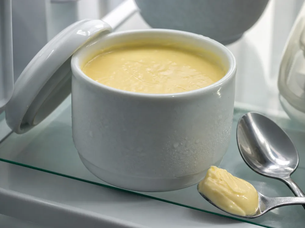 Covered cup cheese in a chilled ceramic cup with a clean spoon - Cup Cheese | KnowTheCheese