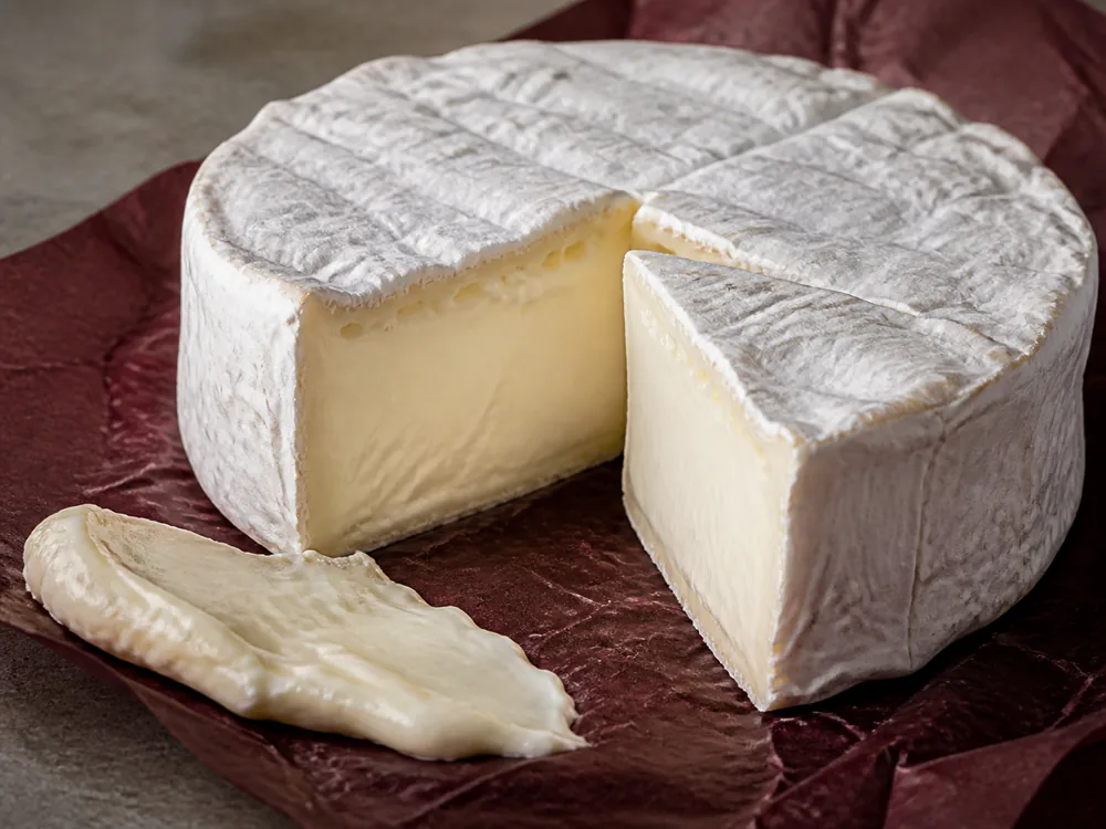 Cut Delice de Bourgogne round with soft paste that still holds its shape