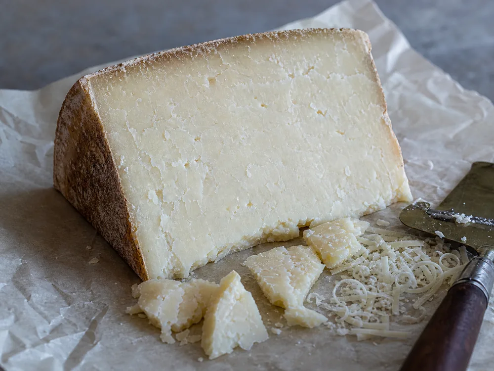 Doddington cheese cut face with natural rind shards and grated curls - Doddington | KnowTheCheese