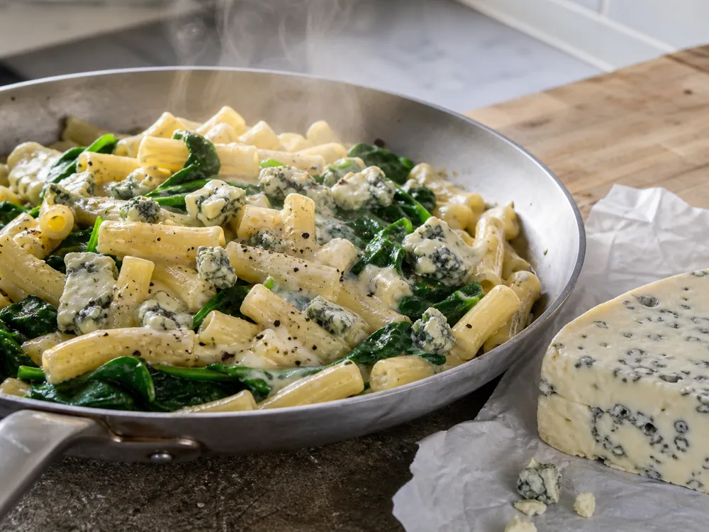 Dolcelatte cheese melting into pasta with spinach - Dolcelatte | KnowTheCheese