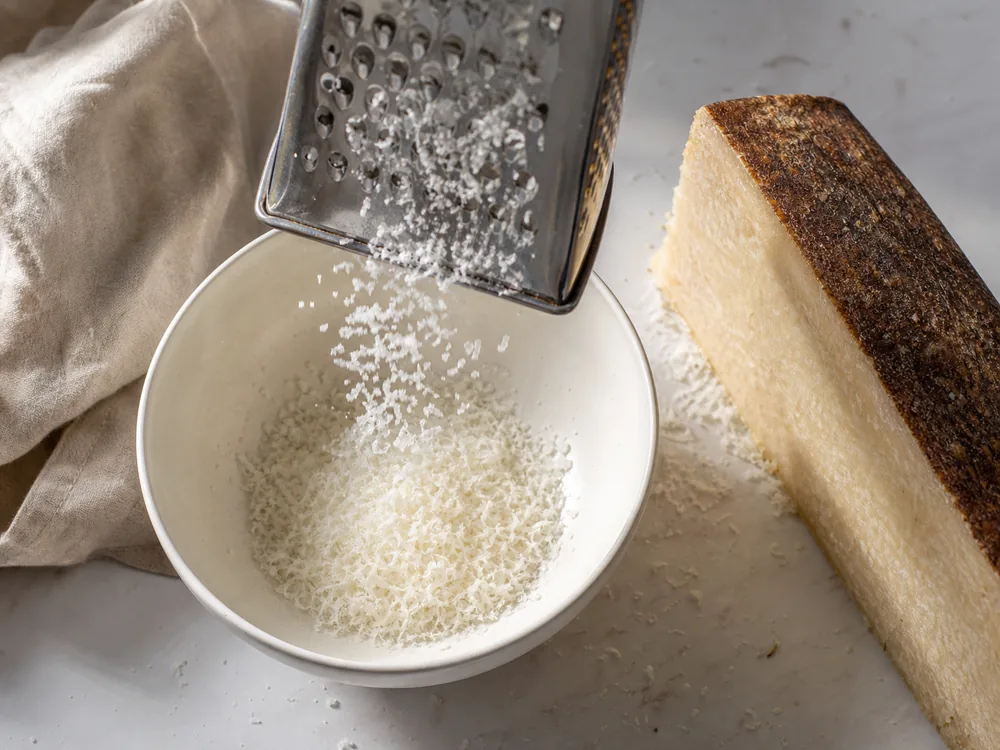Grating Dry Jack cheese into fine pale flakes over a bowl - Dry Jack cheese | KnowTheCheese