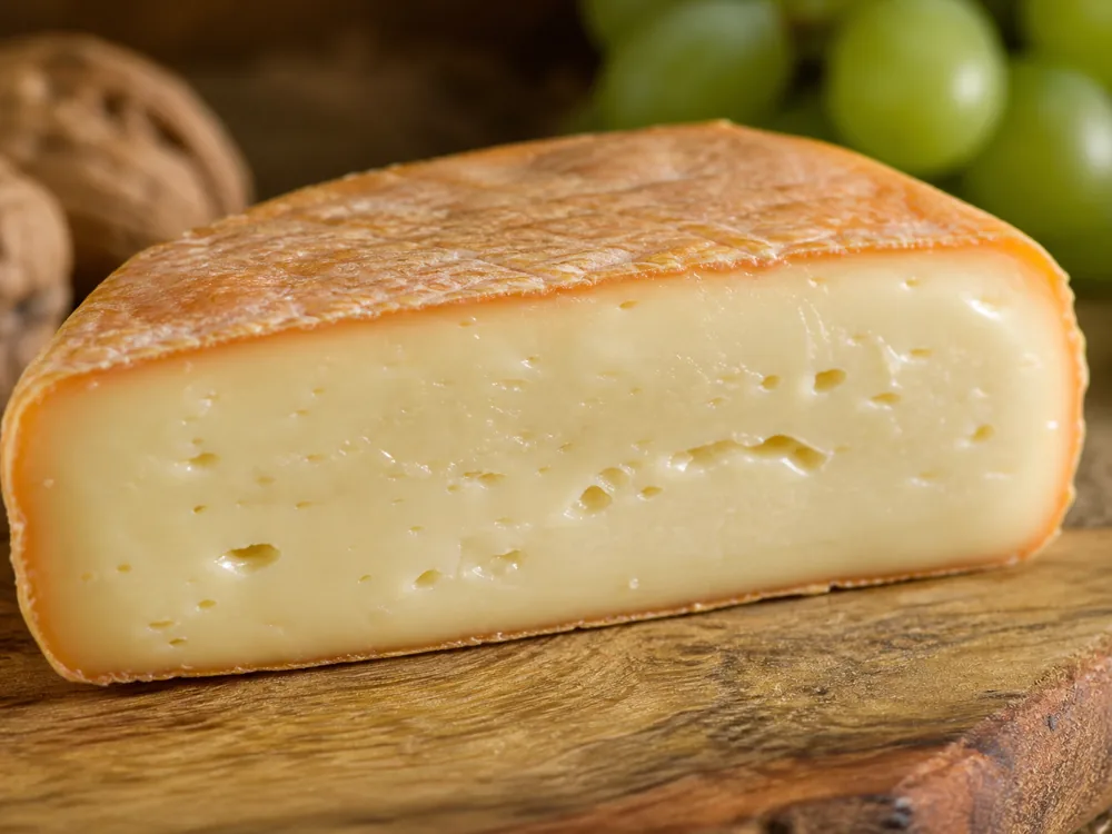 Close-up of the moist paste and washed rind of Durrus cheese - Durrus cheese | KnowTheCheese