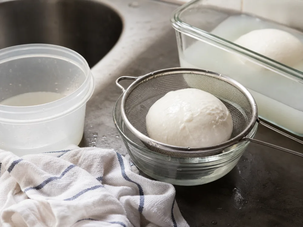 Fior di latte draining in a sieve before storage or pizza prep - Fior di Latte | KnowTheCheese