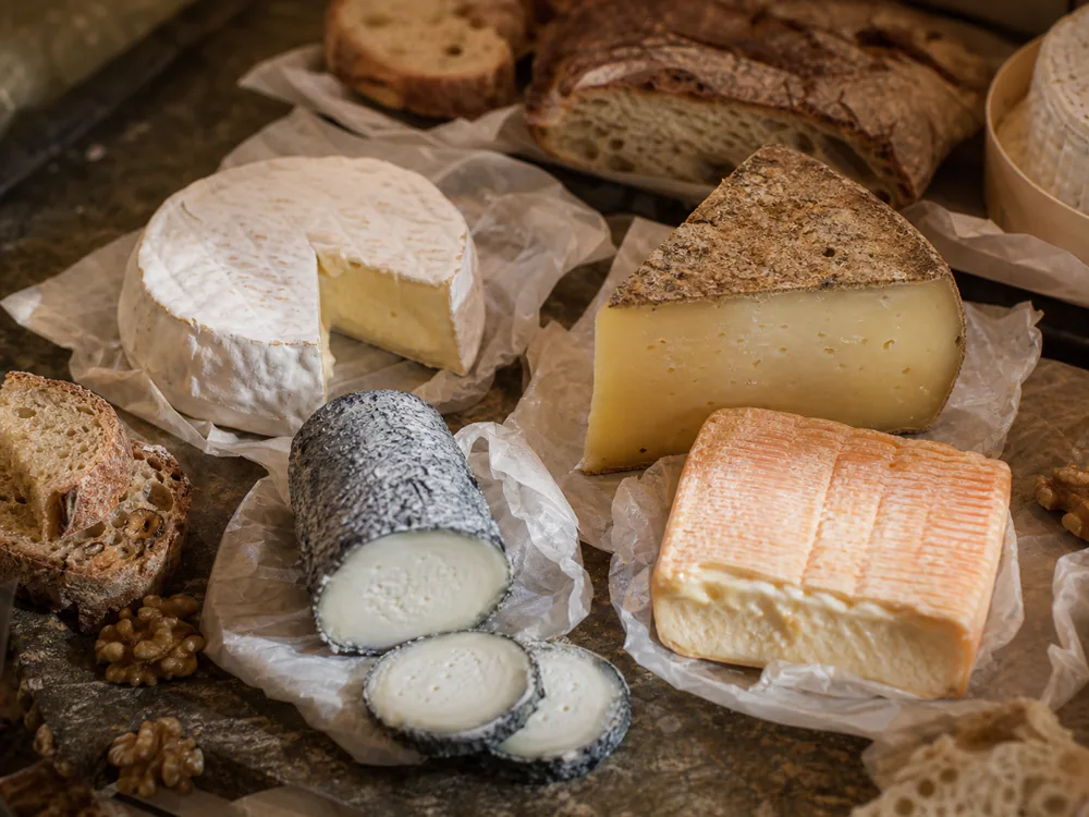 French cheese board with bloomy rind, goat cheese, mountain cheese, and washed-rind styles