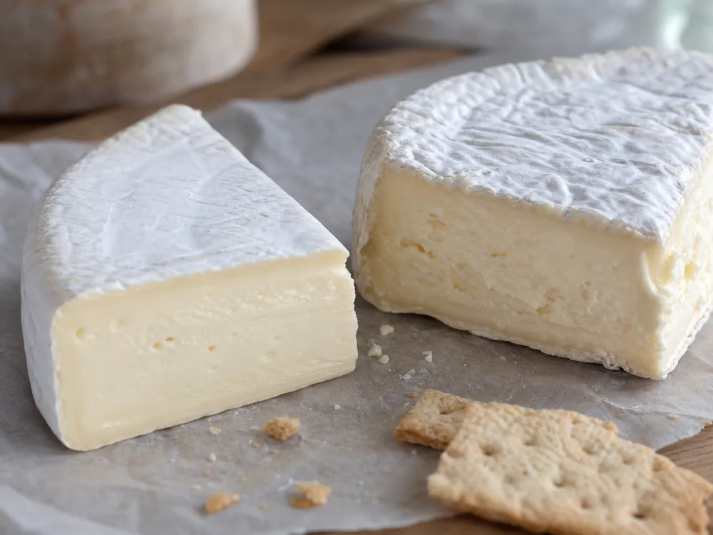 Silky Fromager d'Affinois-style wedge beside a firmer Brie-style wedge - Fromager d'Affinois | KnowTheCheese