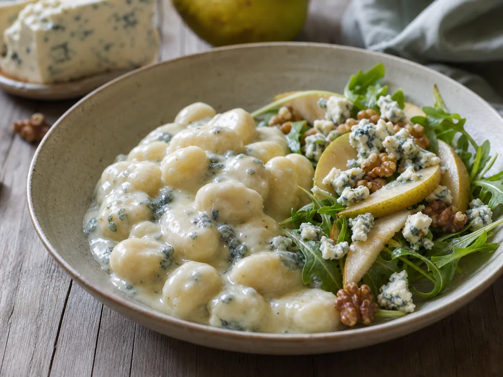 Gorgonzola Dolce melting into gnocchi while Piccante crumbles sit on pear salad - Gorgonzola cheese | KnowTheCheese