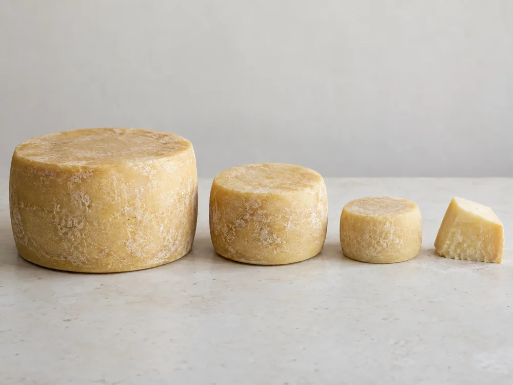 Four Graviera pieces lined up from a large wheel to a small portion - Graviera | KnowTheCheese