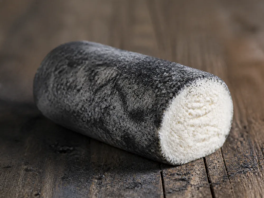 Goat cheese log dusted with dark vegetable ash for Grey Owl cheese - Grey Owl cheese | KnowTheCheese