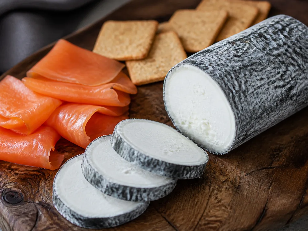 Grey Owl cheese served on a board with smoked salmon and crackers - Grey Owl cheese | KnowTheCheese