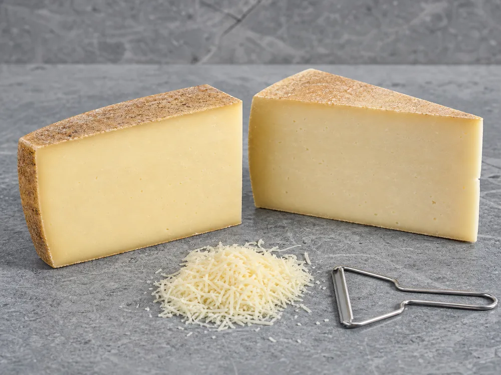 Comte-style and Gruyere-style wedges with dense pale paste and fresh gratings - Gruyere substitutes | KnowTheCheese